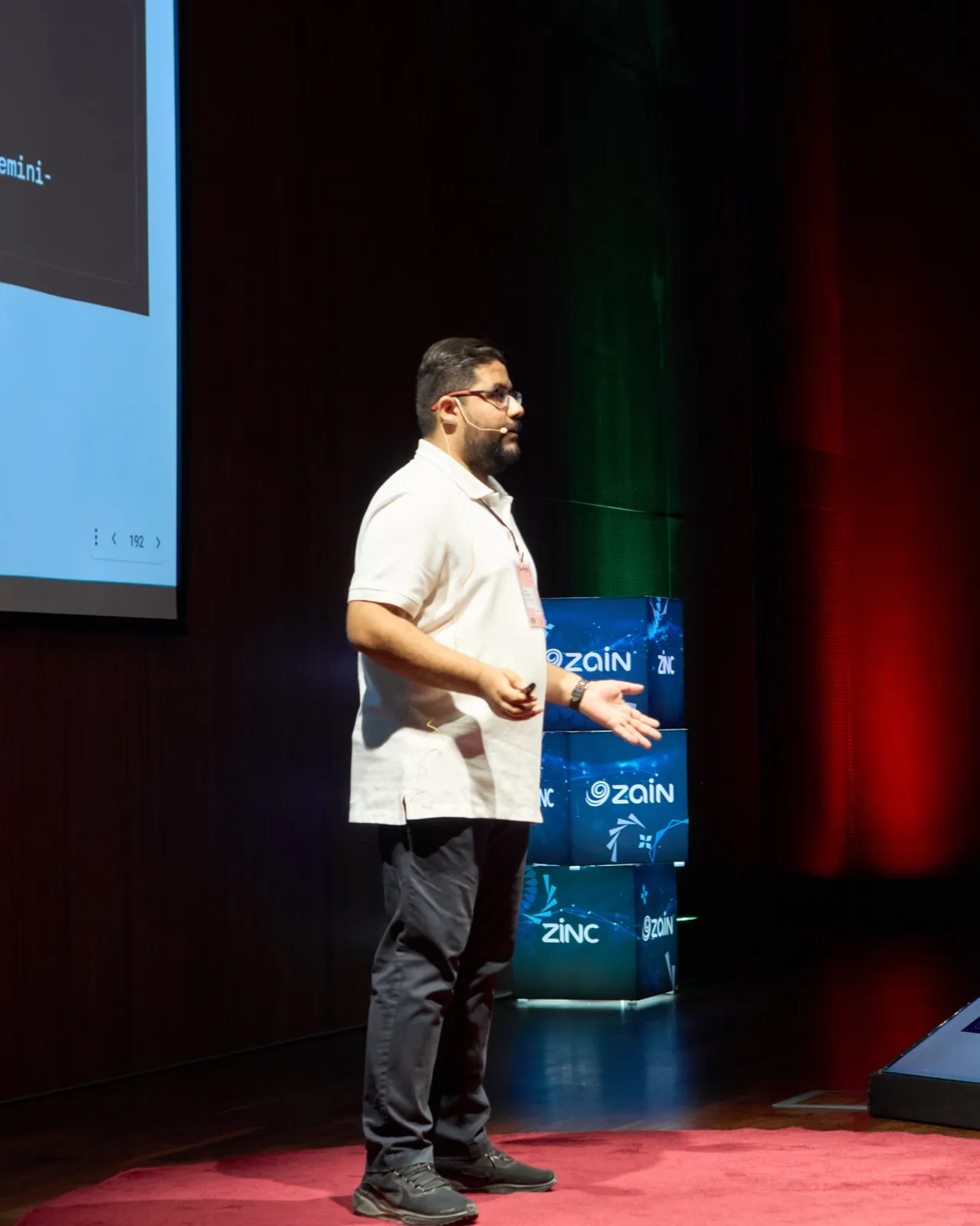 Sayed Ali Alkamel presenting on stage at DevFest Amman 2024