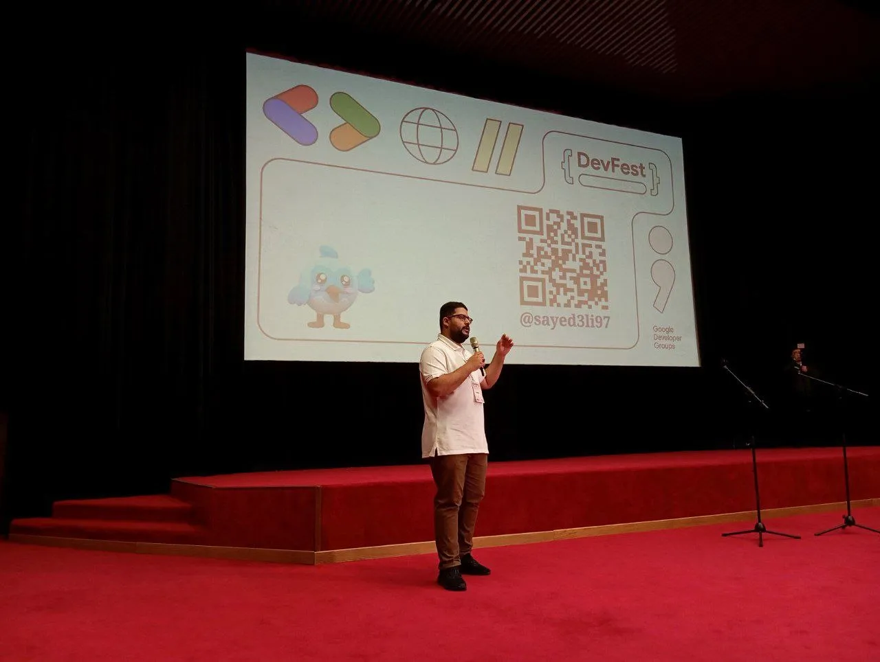 Sayed Ali Alkamel speaking on stage at DevFest Tashkent 2024